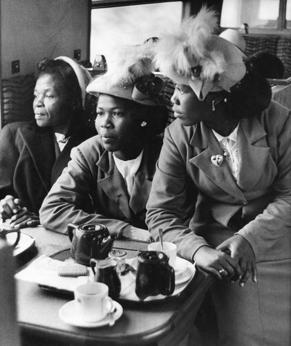 130 passengers arrived in Southampton, emigrating to Britain from the West Indies. Sisters Veronica and Velveta McGregor (on right) take tea in the train on their way to London, where their father will be waiting. 1953