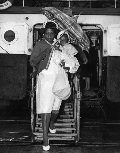 Wet welcome for immigrant West Indians. A West Indian mother and child catch a first glimpse of the land which is to become home, as they arrive in Southampton docks from the Spanish passenger vessel Montseraat. nearly 300 west Indians arrived on board the Spanish ship. The immigrants are believed to be hurrying to Britain before any rumoured restrictions are made on their entry. 24th October 1961